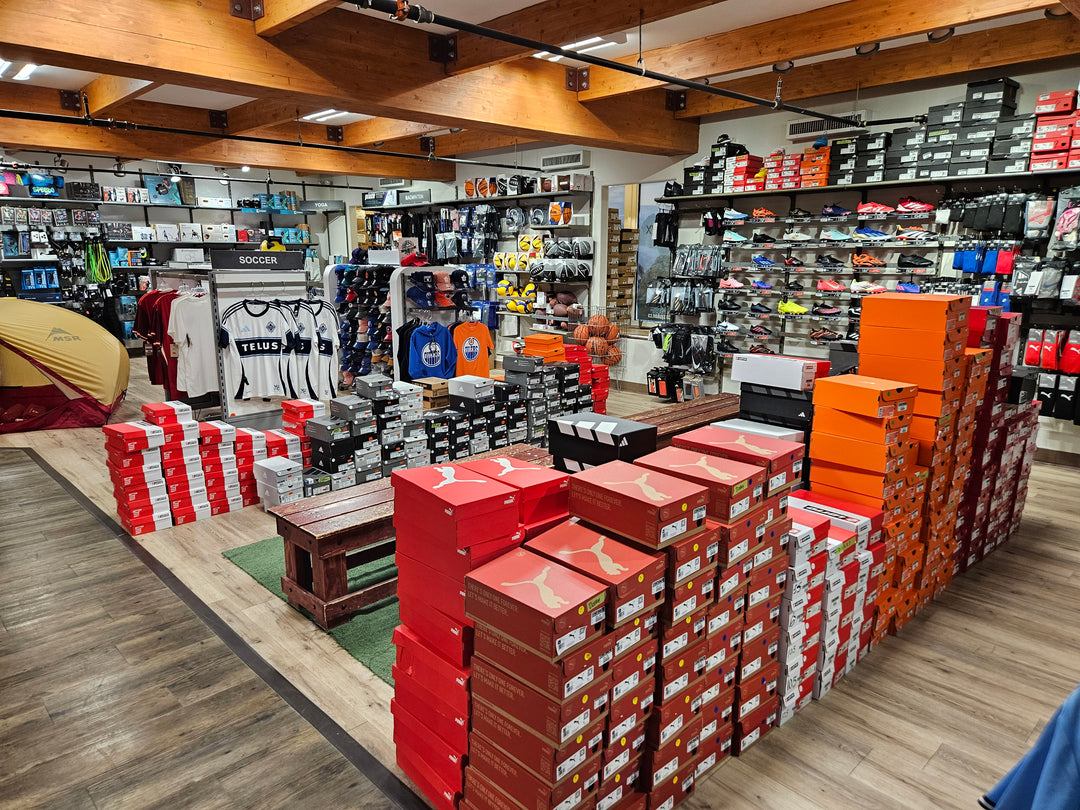Team sports area with soccer jerseys, balls and stacked shoe boxes