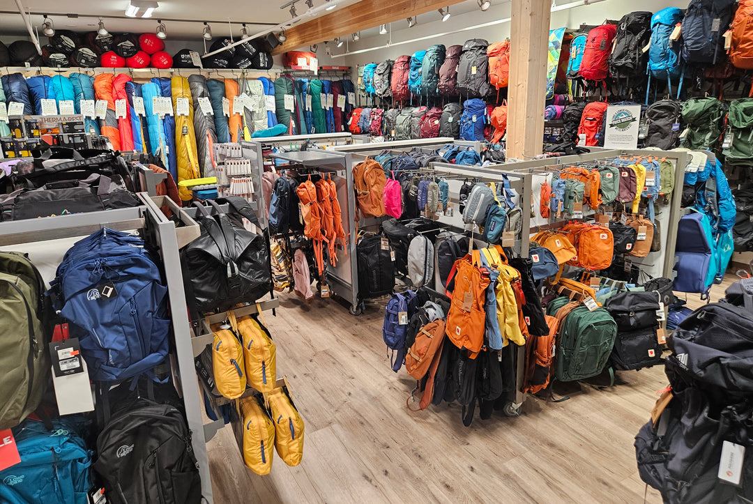 Racks of colourful backpacks and sleeping bags